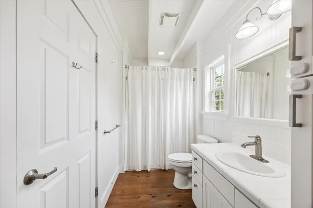 a bathroom with a sink toilet granite tub and shower
