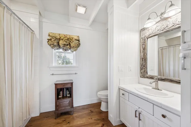a spacious bathroom with a toilet a sink and mirror