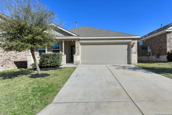 a front view of a house with a garden and plants
