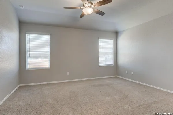 a view of room with window and ceiling fan