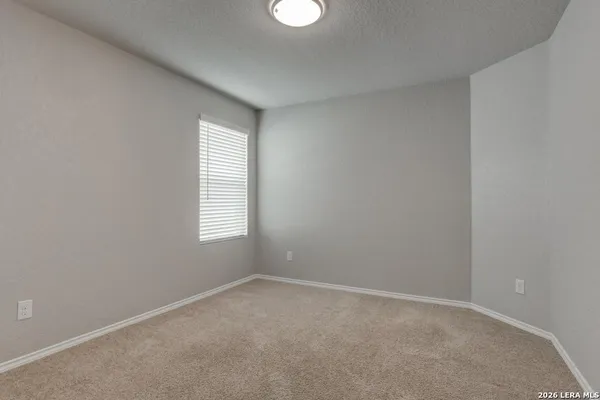 an empty room with a window and closet