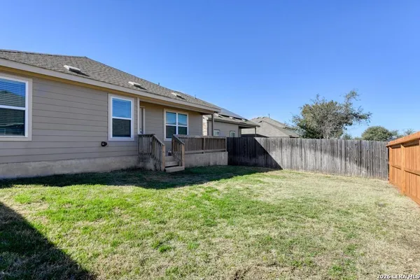 a view of a backyard with a garden and deck