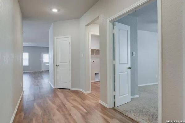 a view of a hallway with wooden floor