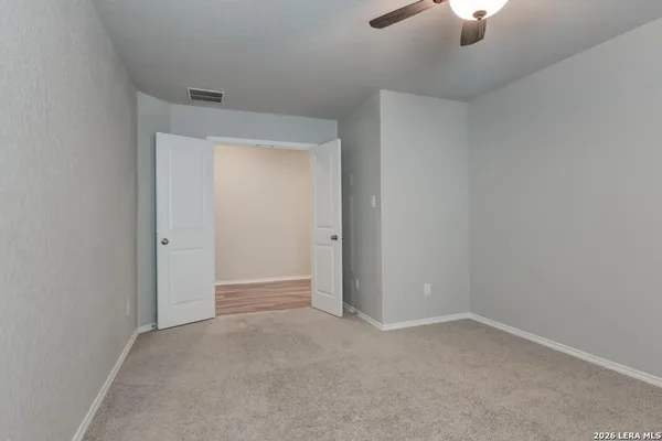 an empty room with a empty space and a ceiling fan