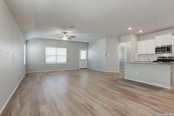 a view of a kitchen with microwave and cabinets