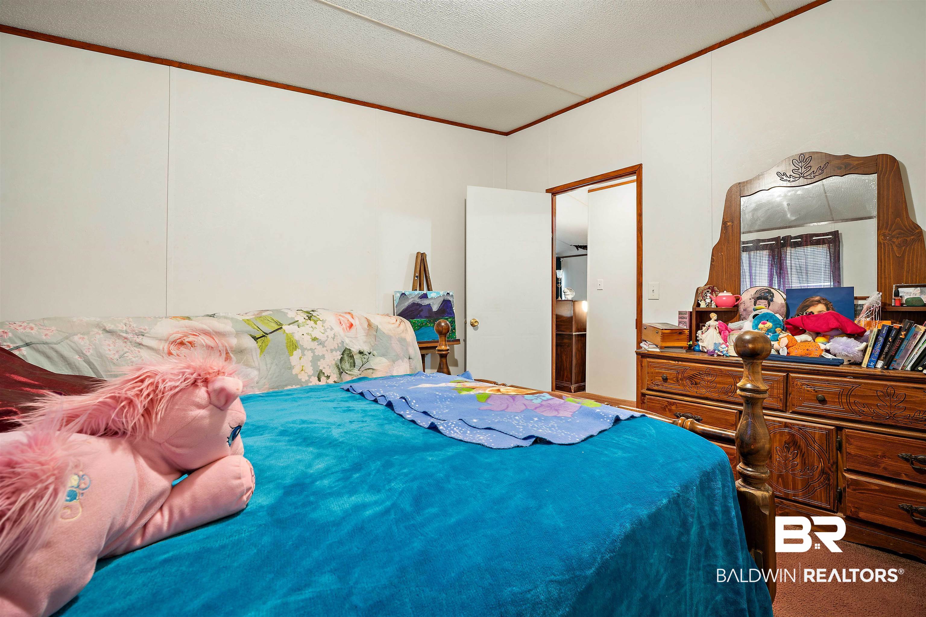 23700 Cumberland Road Robertsdale, AL 36567 - Photo 20 of 33 Bedroom featuring crown molding, carpet floors, and a textured ceiling