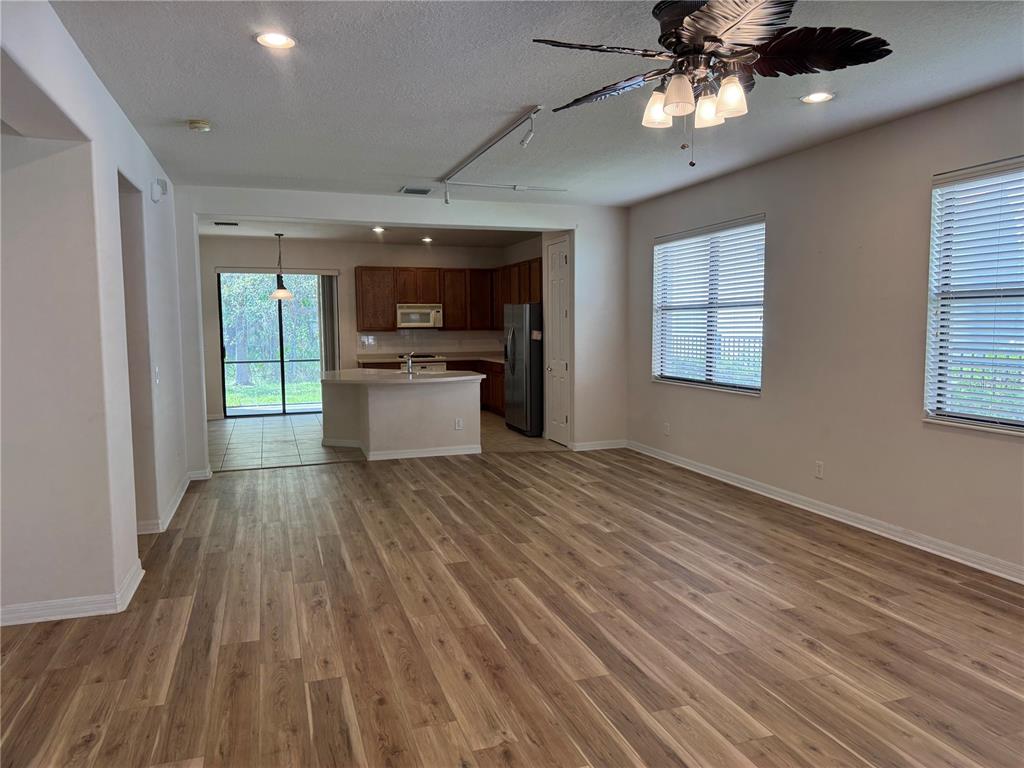8237 Dunham Station Drive Tampa, FL 33647 - Photo 11 of 33 a view of a livingroom with a computer on the desk and wooden floor