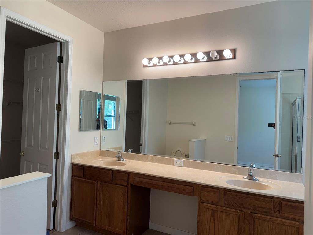 8237 Dunham Station Drive Tampa, FL 33647 - Photo 19 of 33 a bathroom with a sink double vanity and a mirror