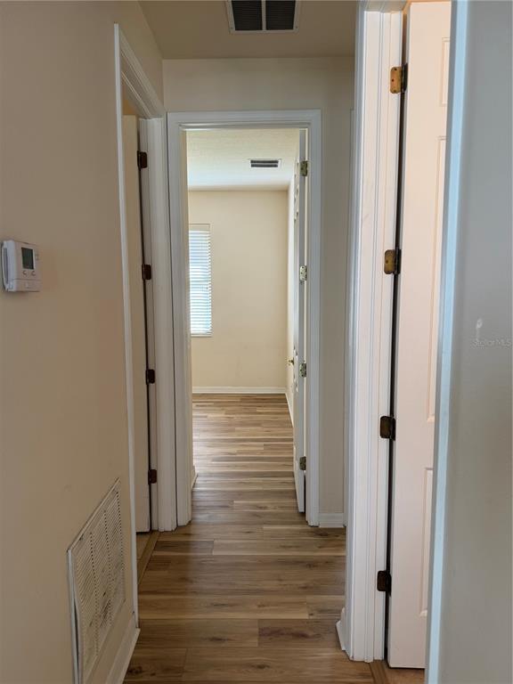 8237 Dunham Station Drive Tampa, FL 33647 - Photo 21 of 33 view of a hallway with wooden floor and closet area