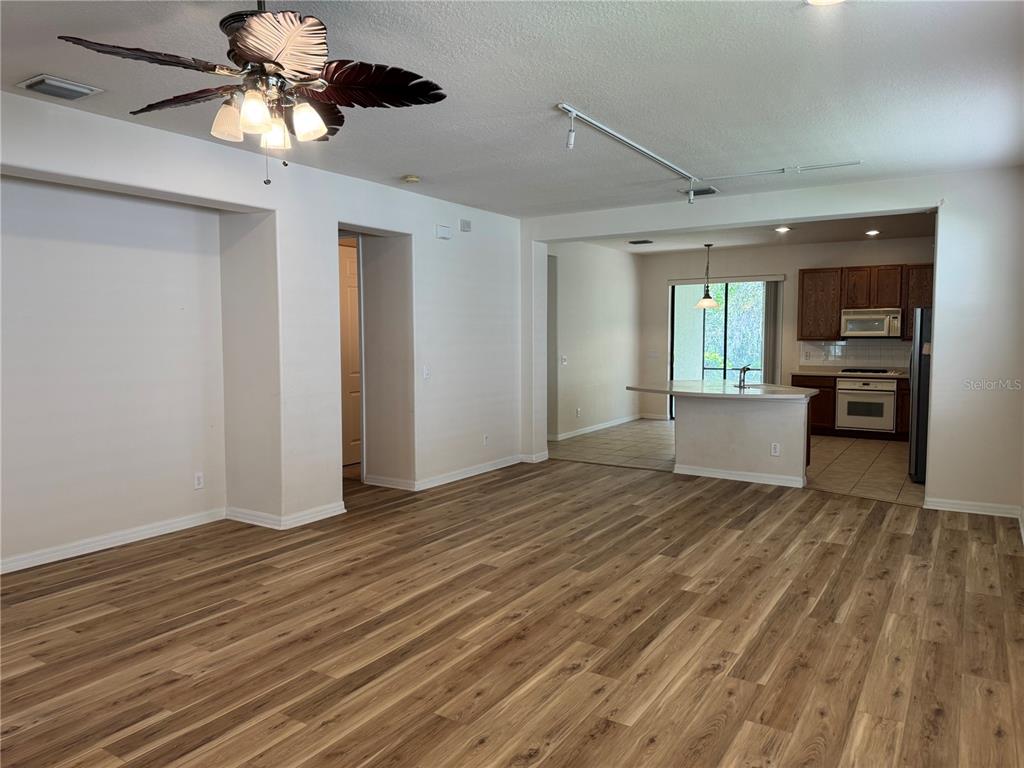 8237 Dunham Station Drive Tampa, FL 33647 - Photo 4 of 33 a view of an empty room and window with wooden floor