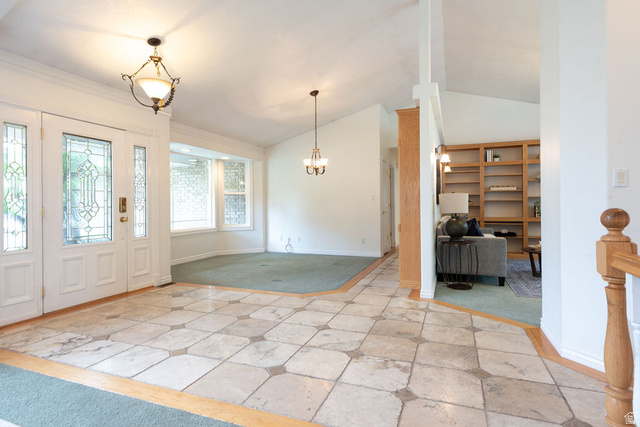 875 East 1300th Street North Mapleton, UT 84664 - Photo 8 of 65 Entrance foyer featuring vaulted ceiling, a chandelier, and light carpet
