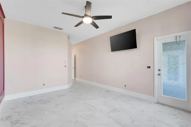 a bed sitting in a bedroom next to a window