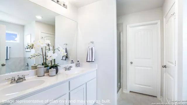 a bathroom with a double vanity sink and a mirror