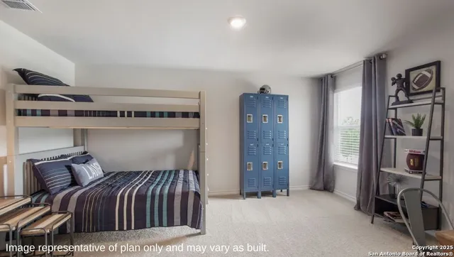 a bedroom with a bed and a refrigerator