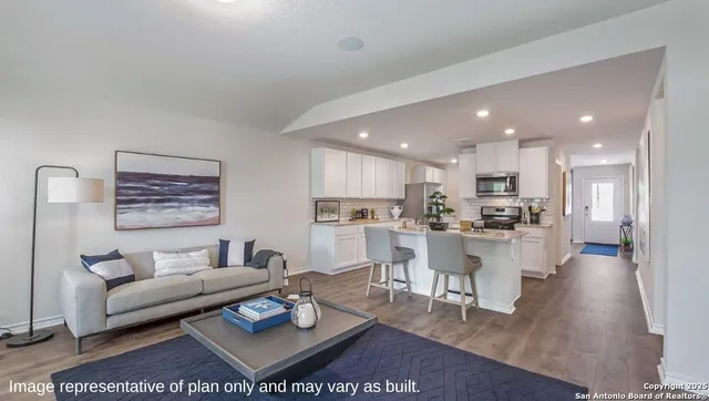 a living room with furniture and kitchen view