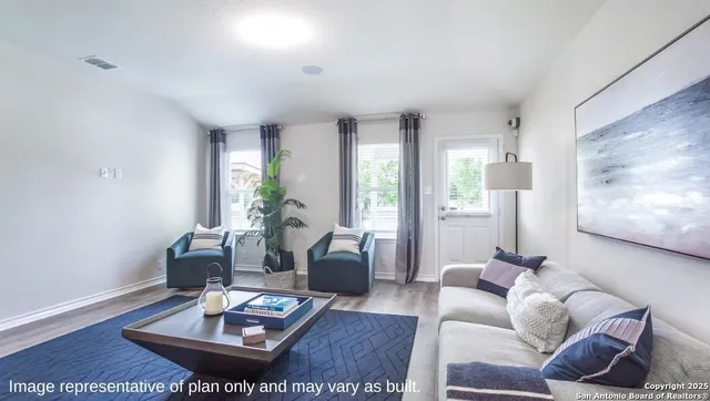 a living room with furniture and a potted plant