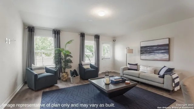 a living room with furniture rug and window