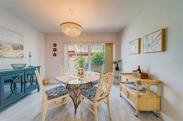 a view of a dining room with furniture and a chandelier