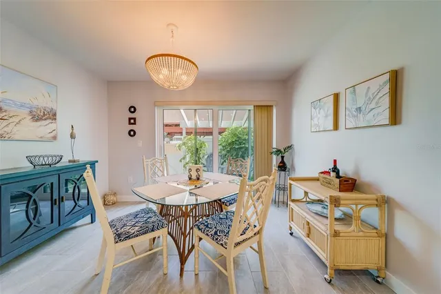 a view of a dining room with furniture and a chandelier