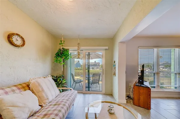 a bedroom with furniture and a large window