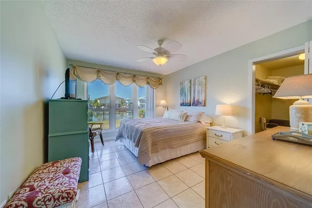 a bed room with a bed window and a flat screen tv