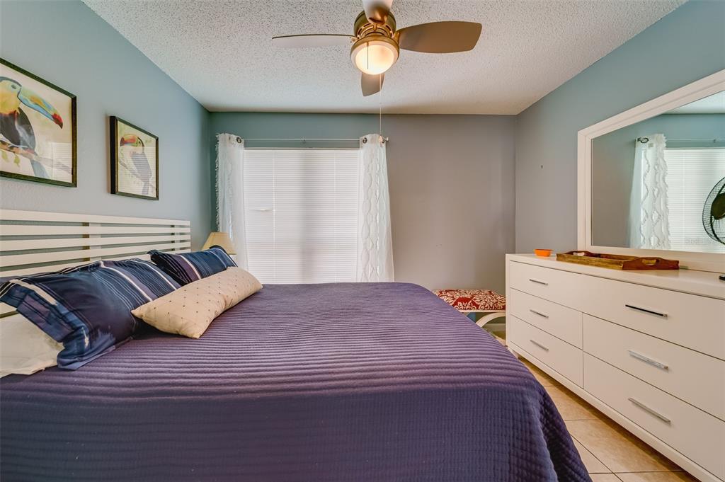 1 Windrush Boulevard, Unit 63 Indian Rocks Beach, FL 33785 - Photo 24 of 60 a bedroom with a bed and window