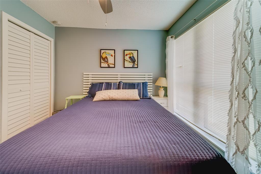 1 Windrush Boulevard, Unit 63 Indian Rocks Beach, FL 33785 - Photo 25 of 60 a bedroom with a bed and a window
