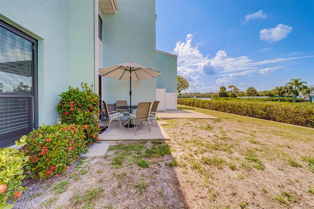 1 Windrush Boulevard, Unit 63 Indian Rocks Beach, FL 33785 - Photo 37 of 60 a view of a backyard