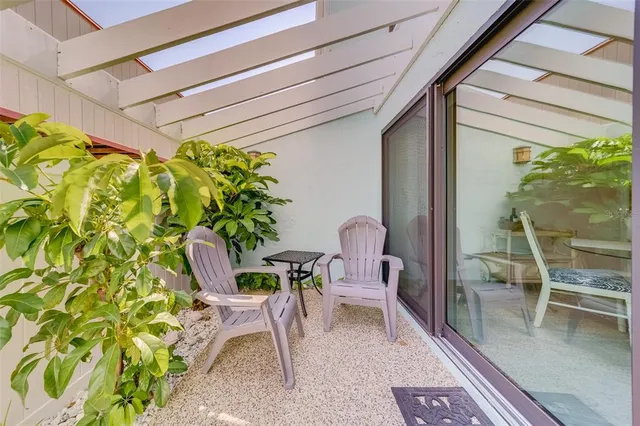 a view of a patio with table and chairs and potted plants