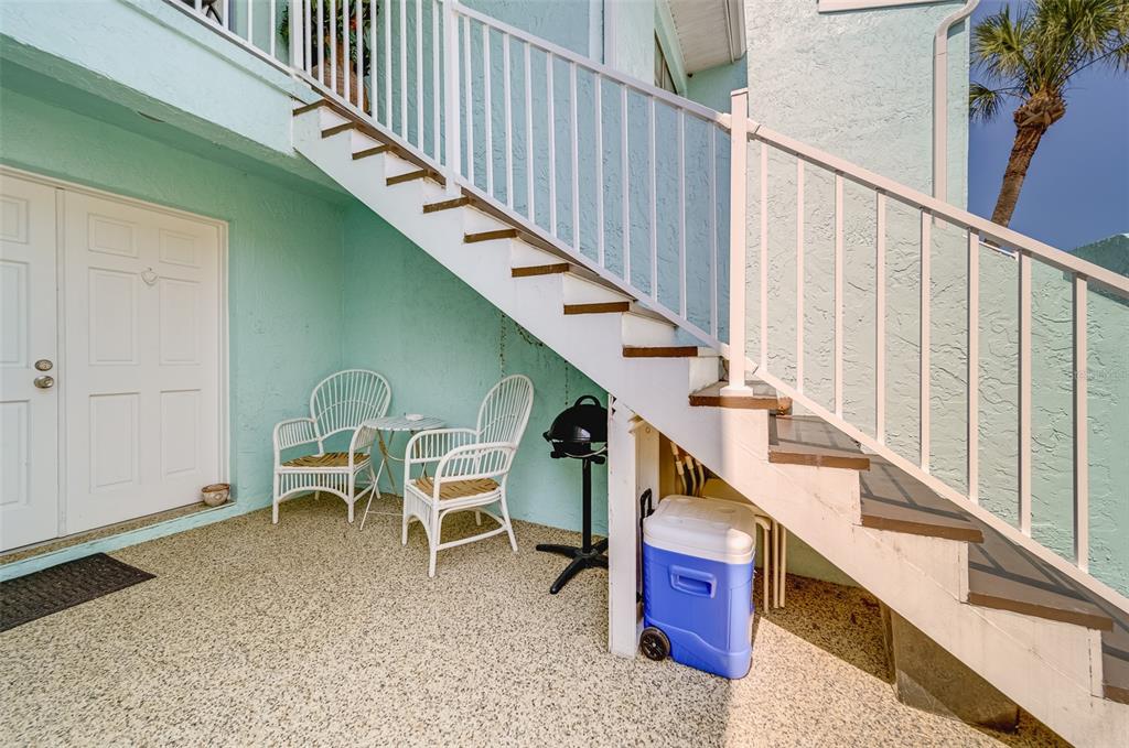 1 Windrush Boulevard, Unit 63 Indian Rocks Beach, FL 33785 - Photo 47 of 60 a balcony with table and chairs