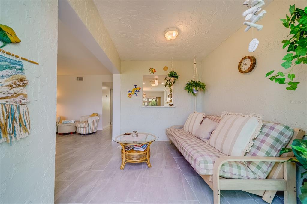 1 Windrush Boulevard, Unit 63 Indian Rocks Beach, FL 33785 - Photo 48 of 60 a living room with furniture and a couch