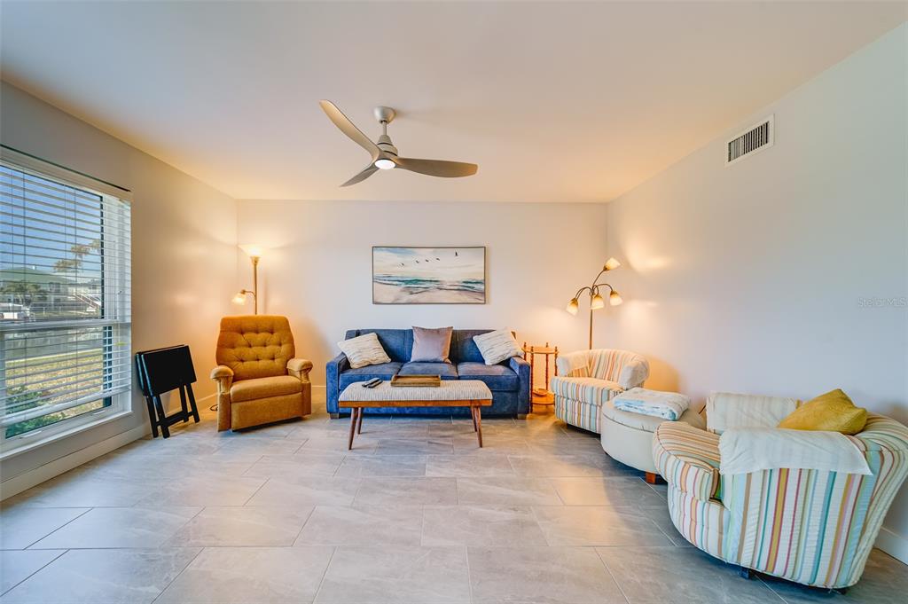 1 Windrush Boulevard, Unit 63 Indian Rocks Beach, FL 33785 - Photo 7 of 60 a living room with furniture and a window