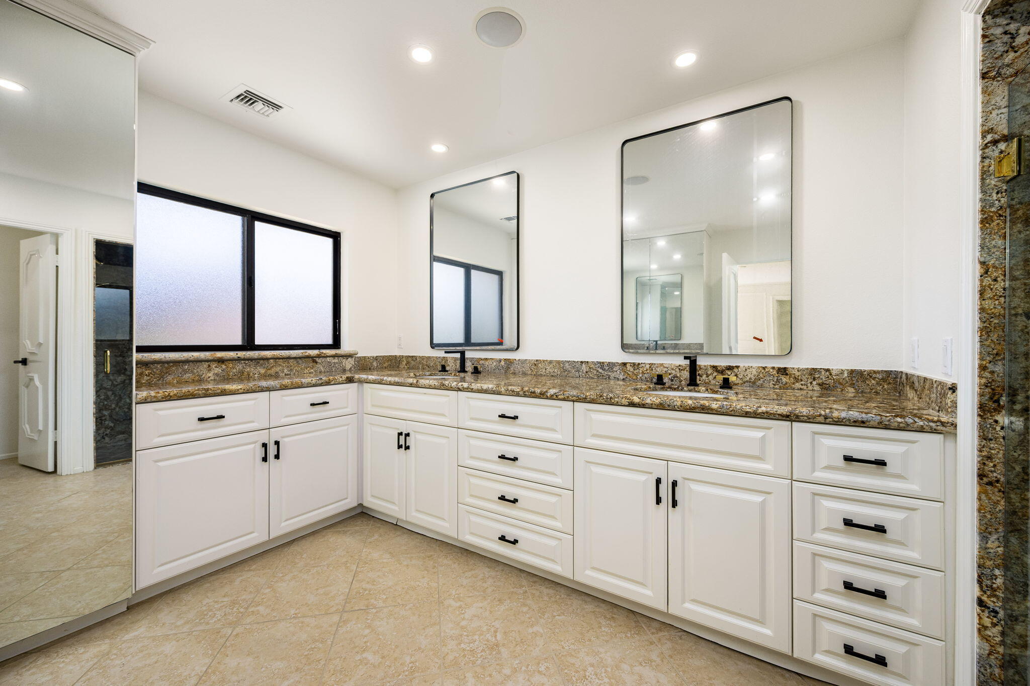 146 Yale Drive Rancho Mirage, CA 92270 - Photo 31 of 63 a spacious bathroom with a granite countertop sink and a mirror