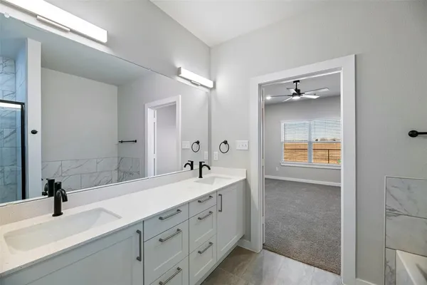 a bathroom with a double vanity sink and mirror
