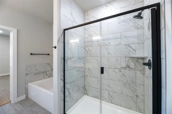 a bathroom with a bathtub and a shower