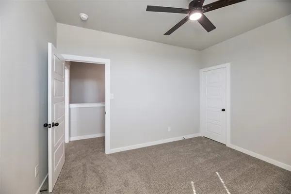 a view of a room with a ceiling fan