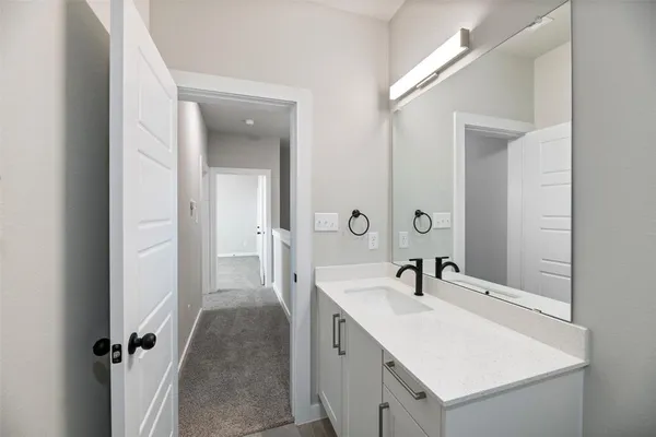 a en suite bathroom with a sink and mirror