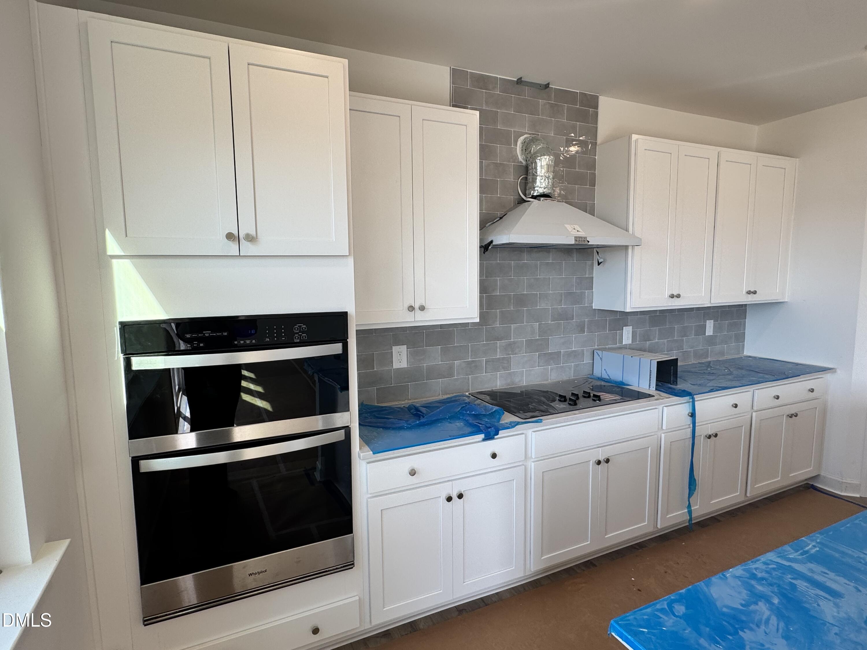 248 Yellow River Way Garner, NC 27529 - Photo 3 of 16 a kitchen with white cabinets and white appliances