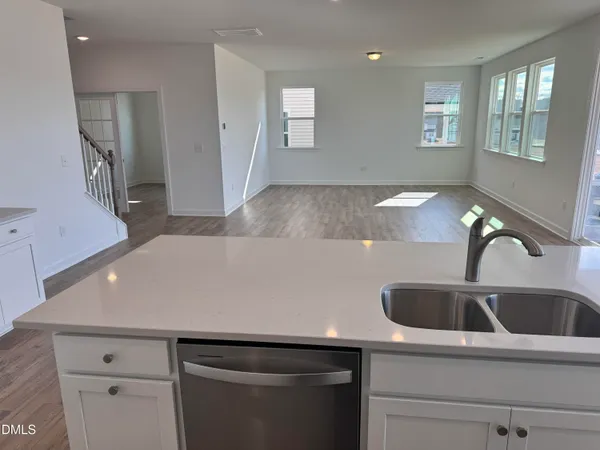 a kitchen with a sink and a refrigerator