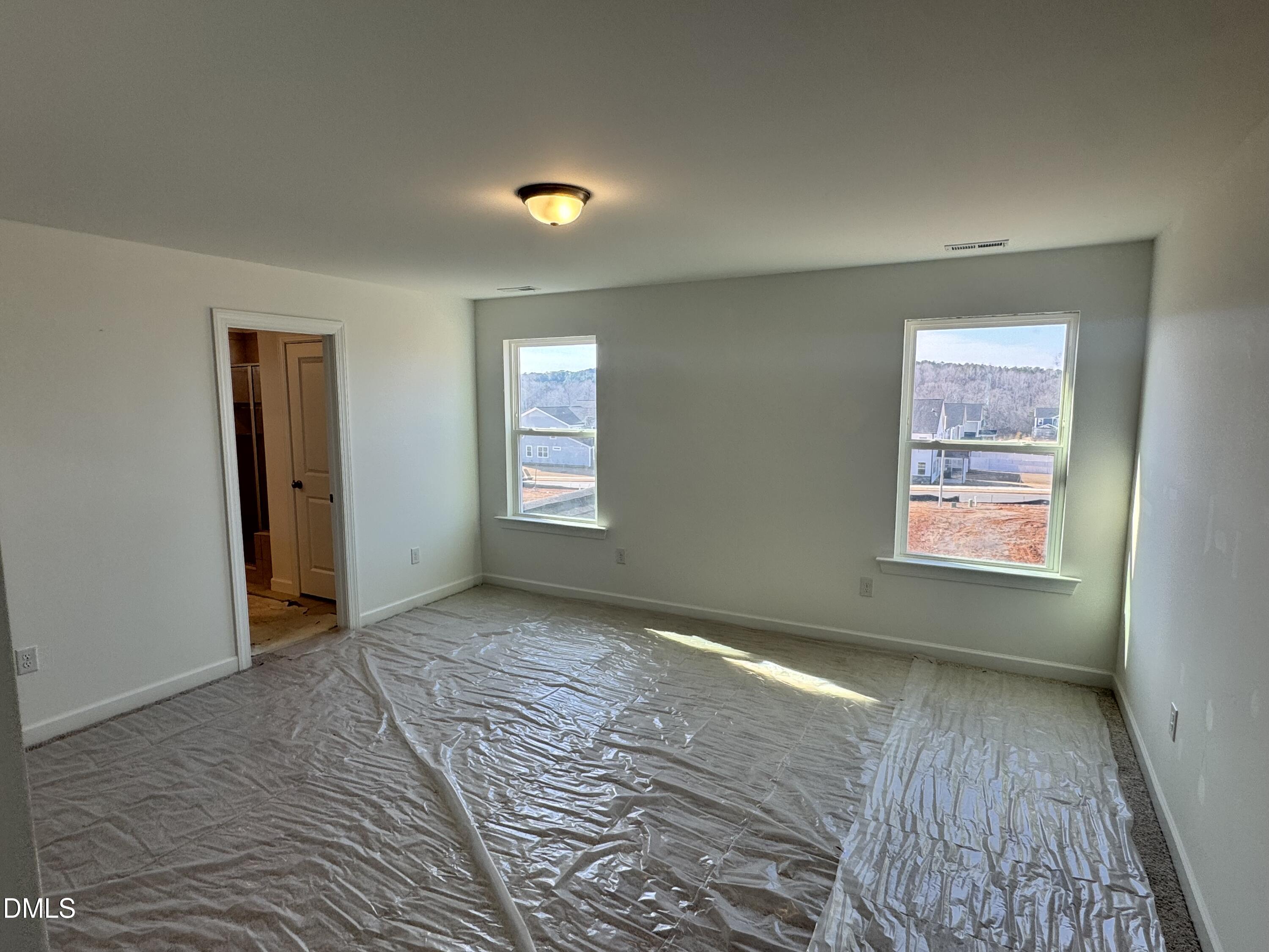 248 Yellow River Way Garner, NC 27529 - Photo 6 of 16 a view of an empty room and window