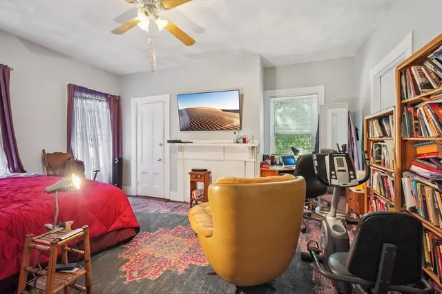 a bedroom with furniture and a flat screen tv