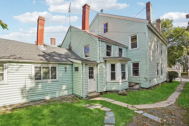 a view of a house with a yard and plants