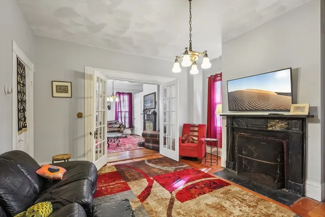 a bedroom with a bed dresser and flat screen tv