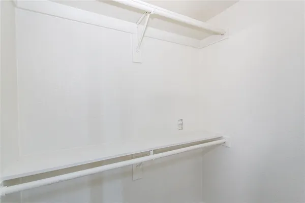 a view of an empty walk in closet