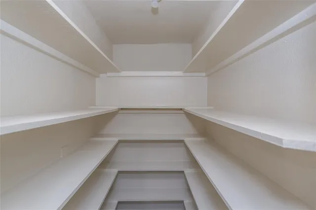 a kitchen with granite countertop wooden cabinets stainless steel appliances and a sink