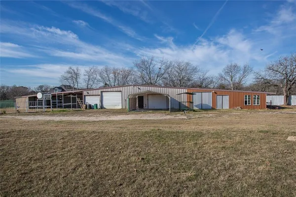 an empty room with fan and entryway