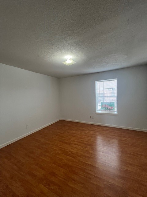 6201 Ranchester Drive, Unit 11 Houston, TX 77036 - Photo 11 of 12 a view of an empty room with wooden floor and a window