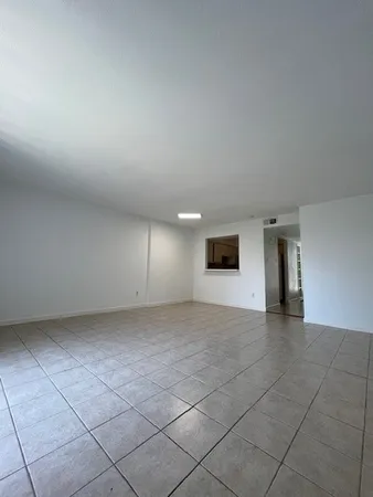 an empty room with a empty space and windows