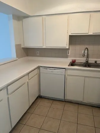 a kitchen with a sink and cabinets