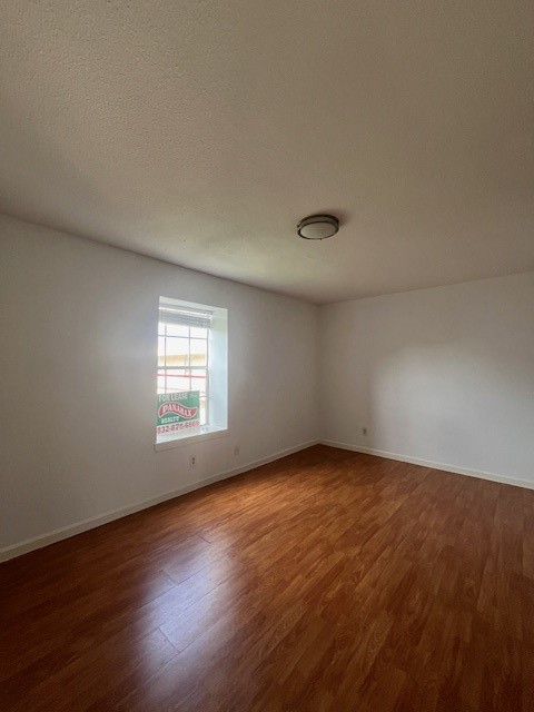 6201 Ranchester Drive, Unit 11 Houston, TX 77036 - Photo 9 of 12 an empty room with wooden floor and windows